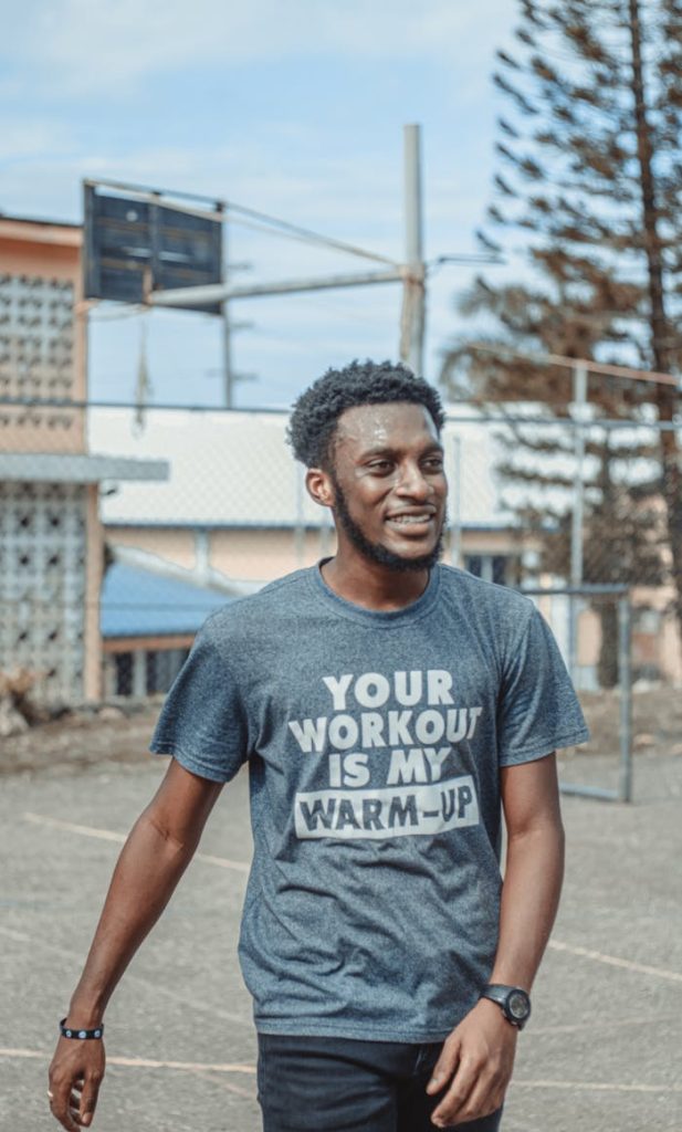 Man in Gray Crew Neck T-shirt Standing on Gray Concrete Pavement