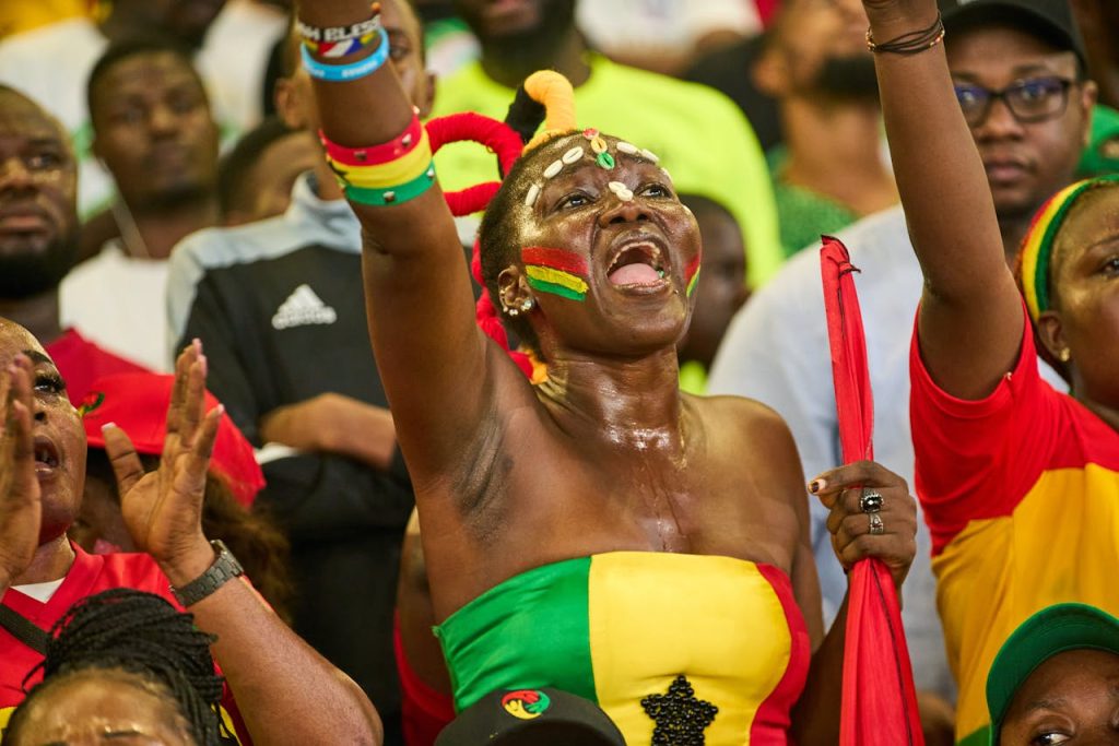 Woman Shouting with Arm Raised at Soccer Game